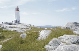 Photo: A lighthouse on a rocky shore.